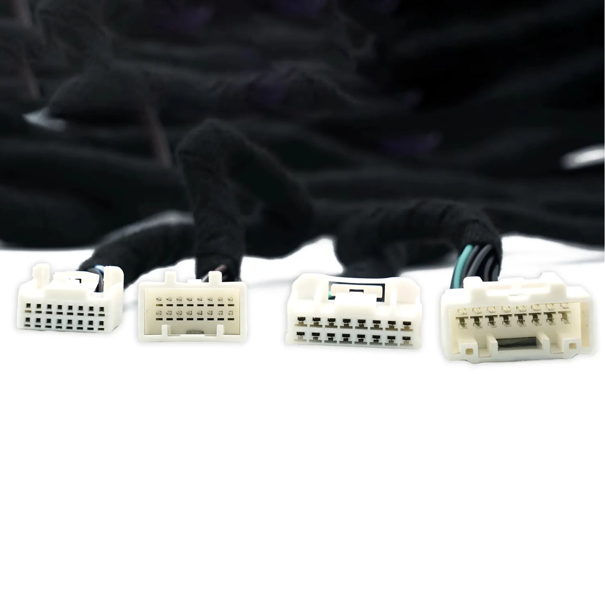 Four white multi-pin connectors on black cables from the Audison Prima AP TSL 3YB 01 are shown side by side against a white background.