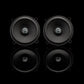 Two black round Gladen Beta 130.2 speakers with a stylized M logo, shown as an auto speaker set on a reflective black background.