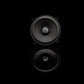 A Gladen Beta 130.2 speaker set is shown with a silver logo in the center, placed on a black background with its glossy reflection beneath.