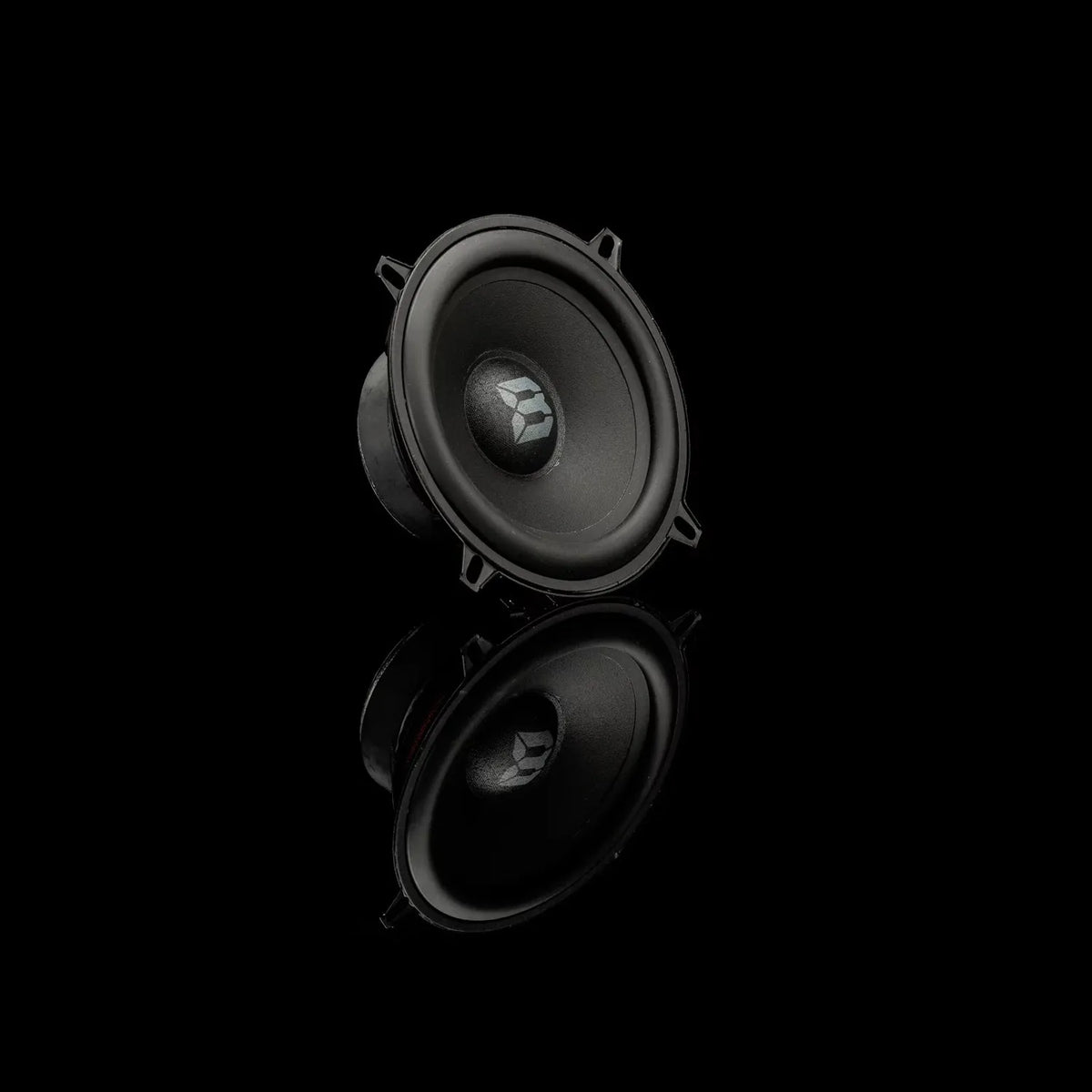 A single Gladen Beta 130.2 faces forward on a black background, its reflection below hinting at its 2-way component system design.