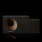 A Gladen Subbox-Buz.1 subwoofer enclosure, black with a round cutout and visible wiring, set against a black background.
