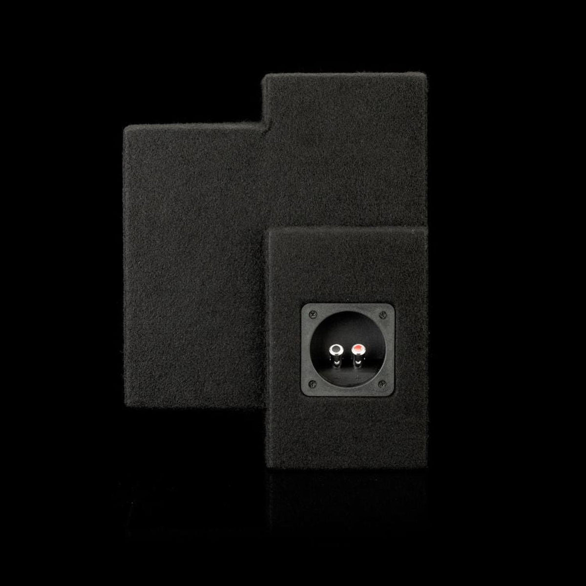 The Gladen Subbox-Buz.2 is a rectangular, carpeted black subwoofer enclosure with a recessed input panel and red/white connectors, shown against a pitch-black background.