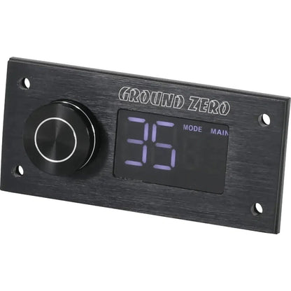 El Ground Zero GZDSP Remote PRO-X es un accesorio DSP negro rectangular con un mando redondo a la izquierda y una pantalla digital que muestra 35 MODE MAIN a la derecha.